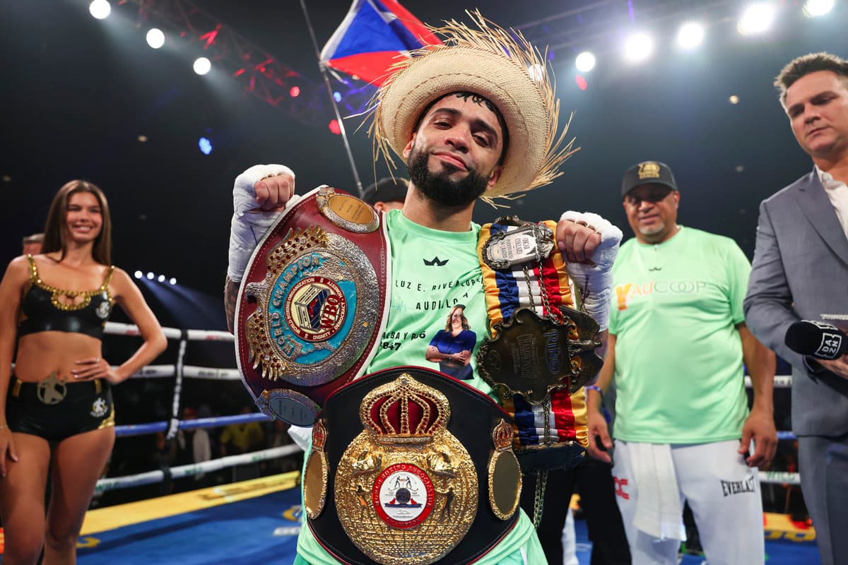Oscar Collazo with his championship belts