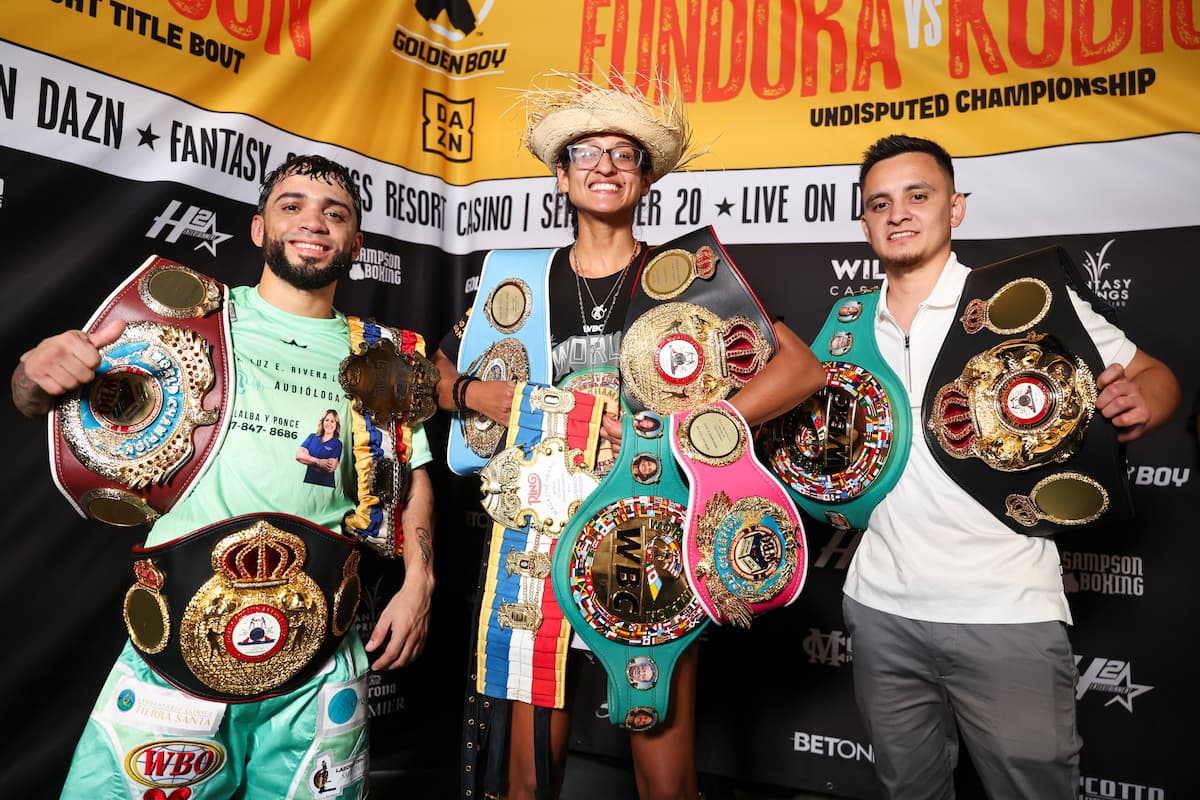 Oscar Collazo, Gabriela Fundora, and Ricardo Sandoval pose with their championship belts