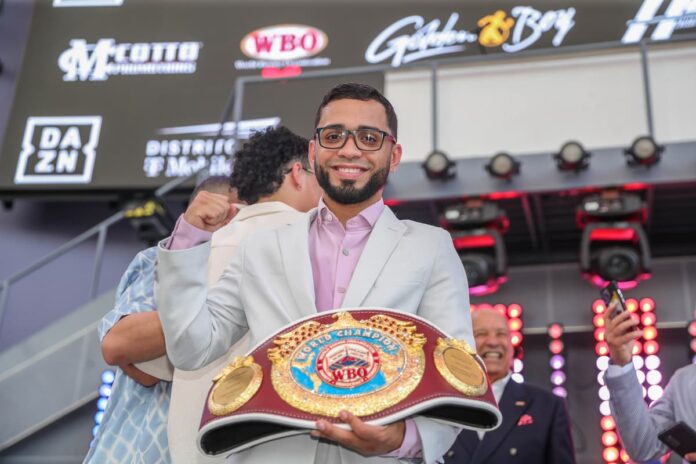 Oscar Collazo poses with his WBO championship belt