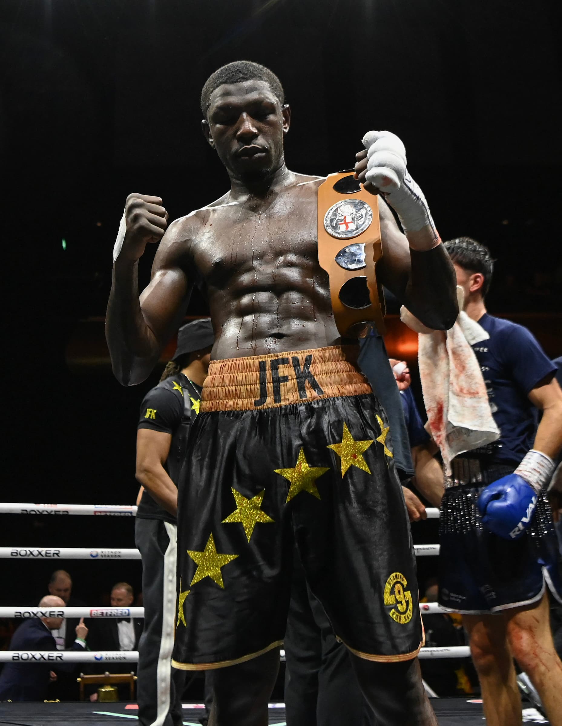 Joel Kodua poses with his championship belt following his victory over Bobby Dalton during their boxing bout