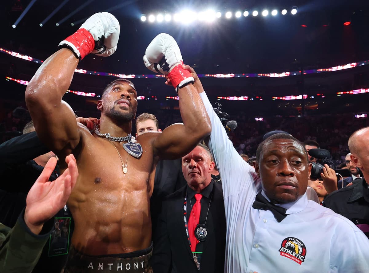 Referee Chris Young raises Anthony Joshua's hand in victory over Jake Paul during their bout