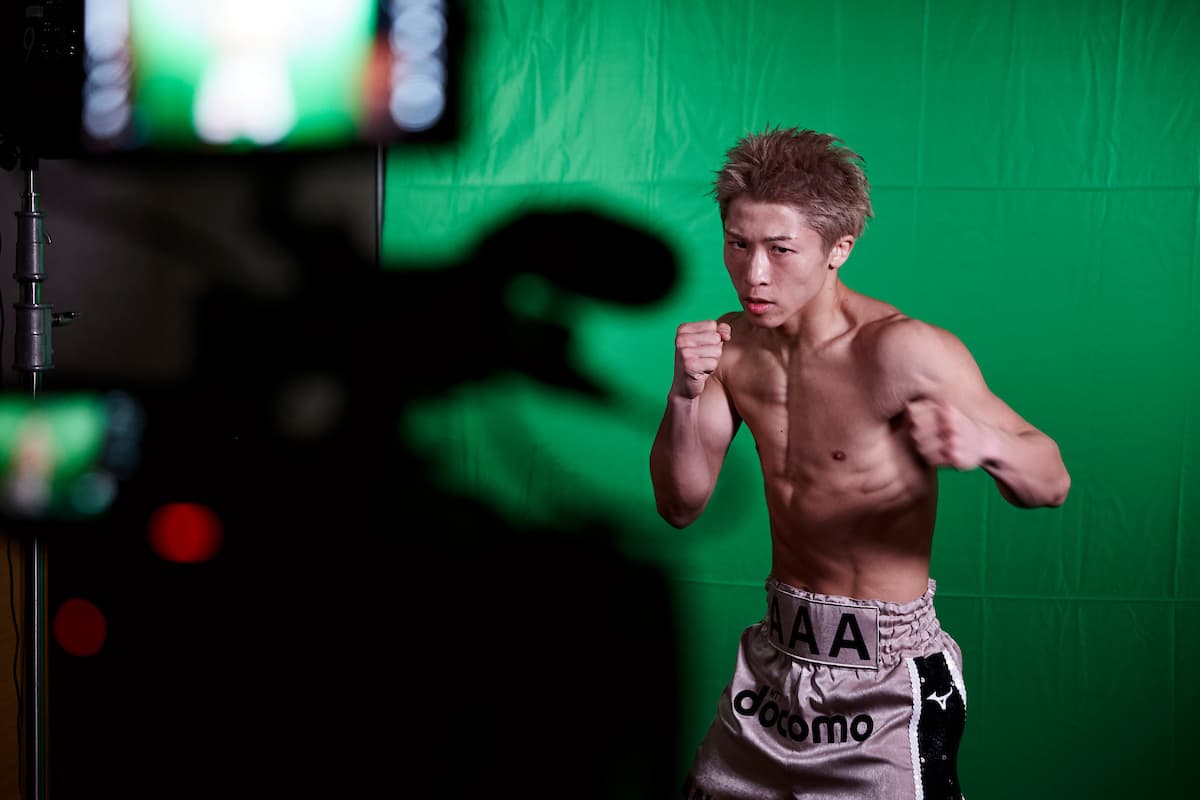 Naoya Inoue posing in front of a green screen