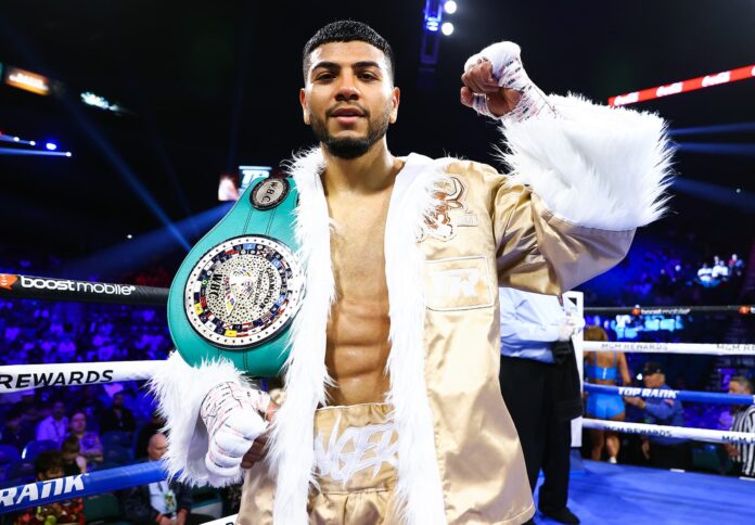 Raymond Muratalla poses with his championship belt after winning a boxing match