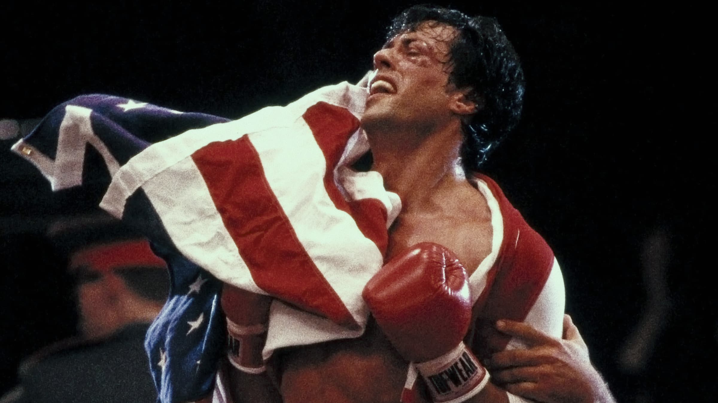 Sylvester Stallone as Rocky Balboa holding a U.S. flag in a production still from the Netflix documentary