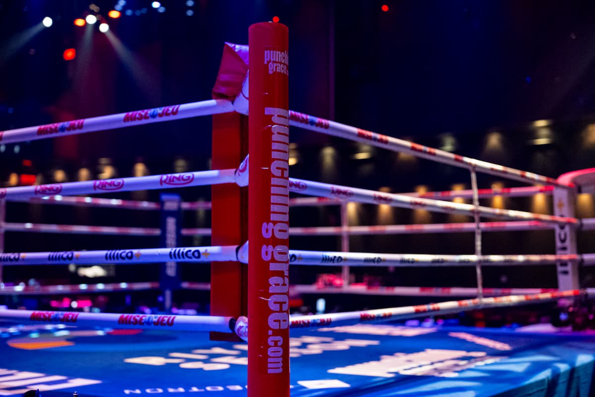 Red corner of a boxing ring with punchinggrace.com branding at Cabaret du Casino in Montreal