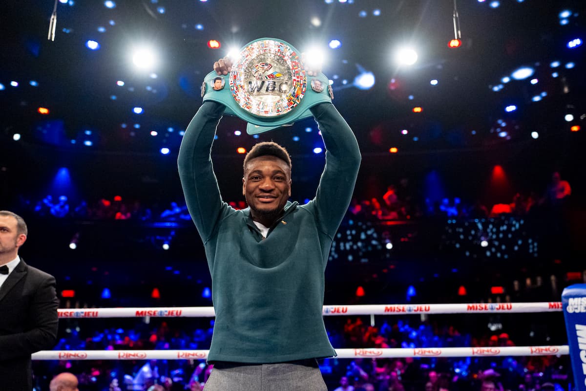 Christian Mbilli raises the WBC championship belt above his head
