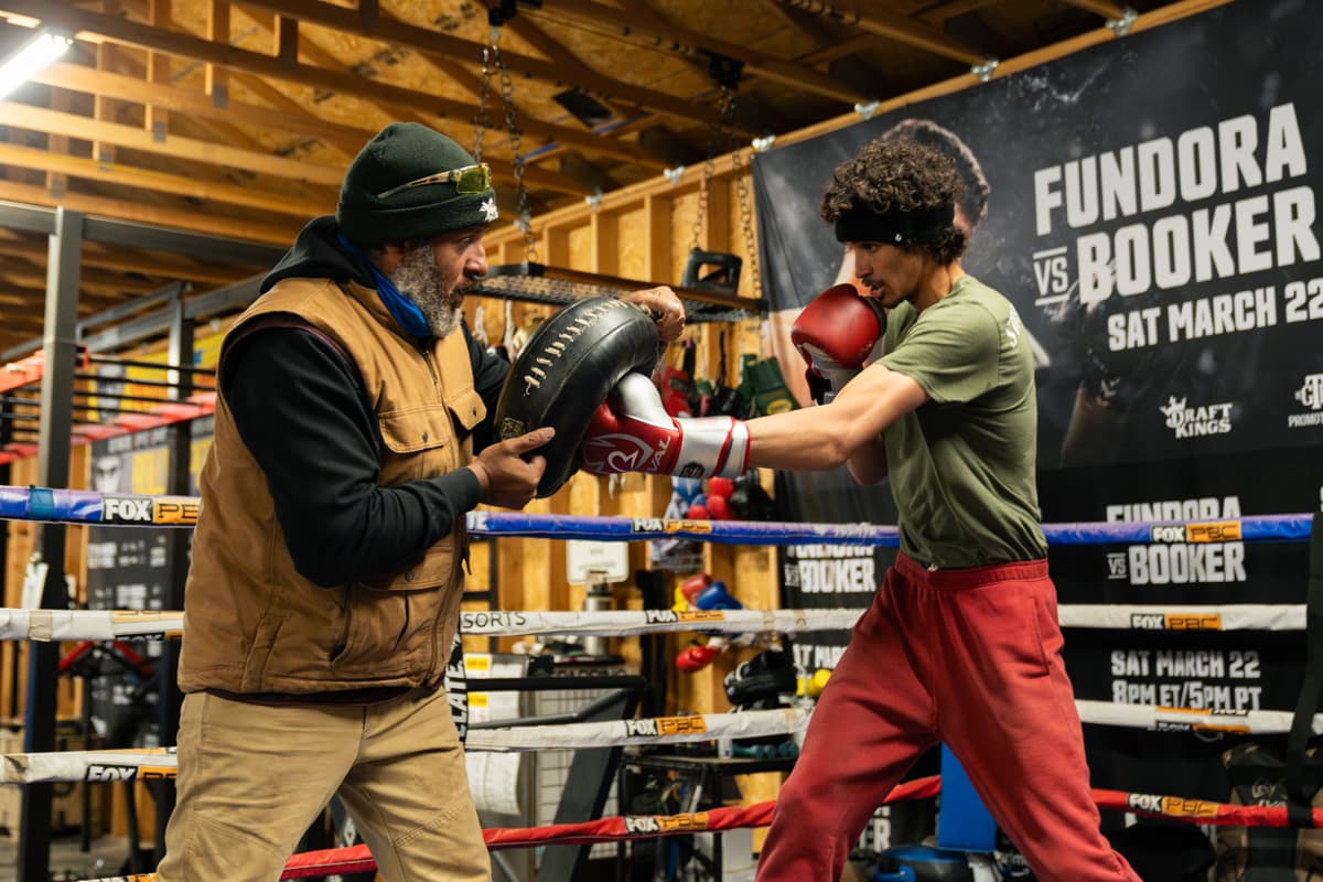 Freddy Fundora holding pads while Sebastian Fundora practices punches during a training session