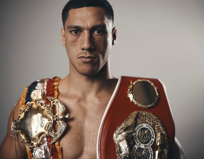 Jai Opetaia holding his IBF and Ring Magazine belts
