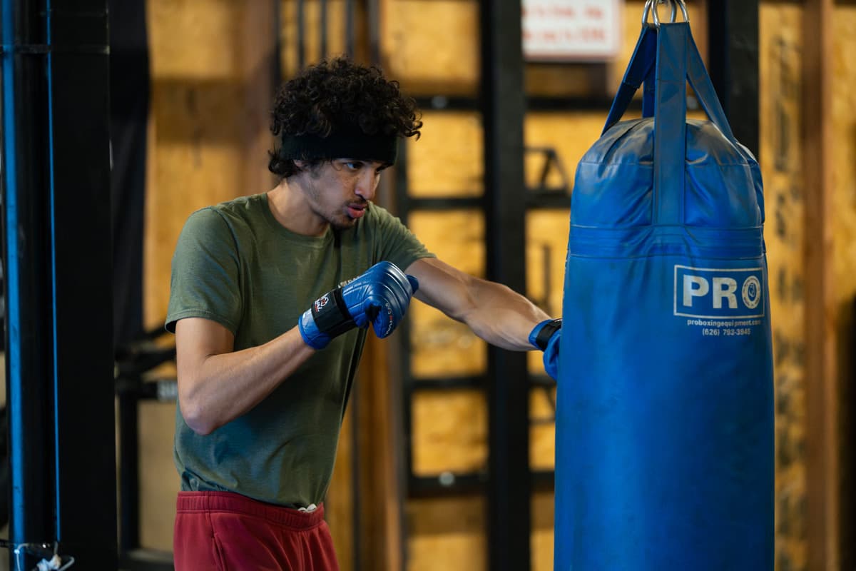Sebastian Fundora punching a boxing bag during a training session