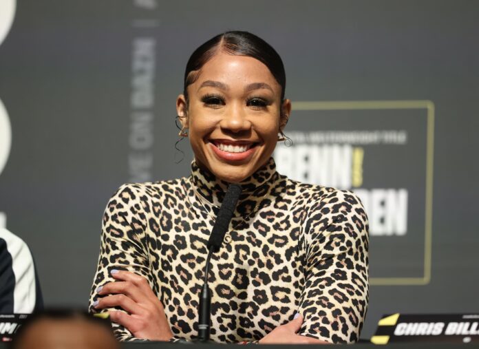 Alycia Baumgardner smiling during a press conference ahead of her boxing match