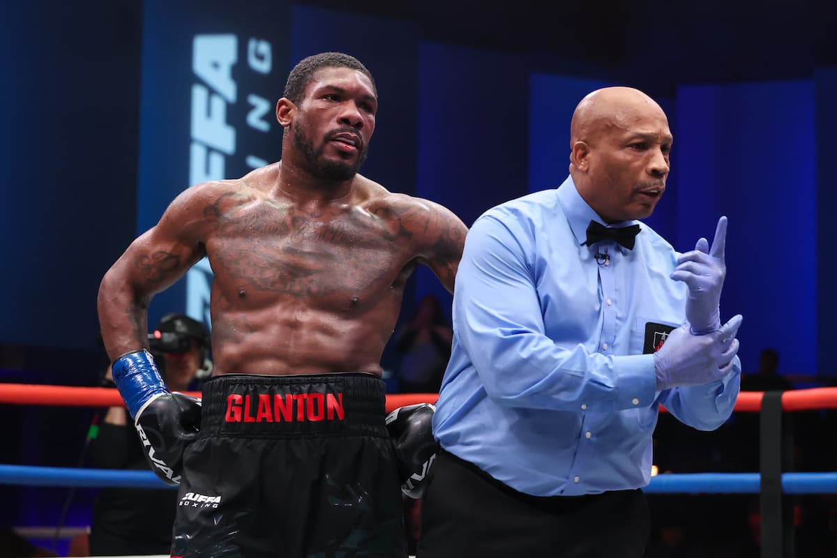 Referee Allen Huggins deducts a point from Brandon Glanton