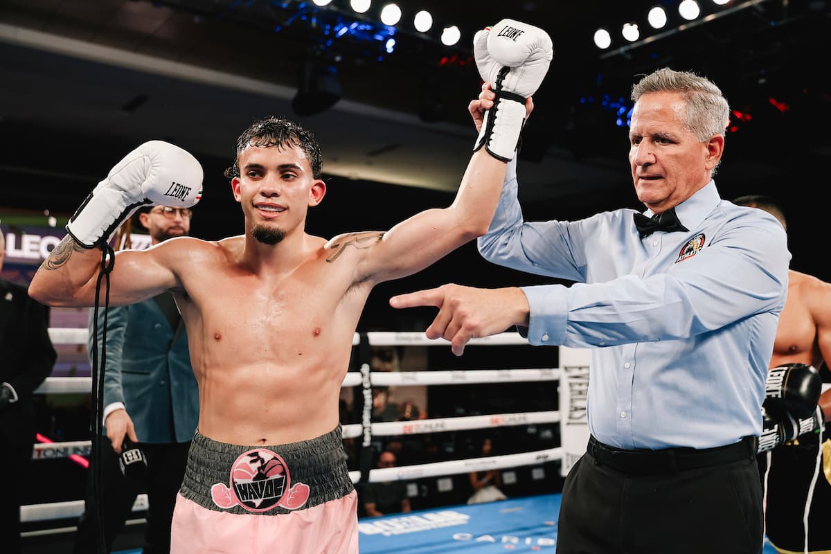 The referee raises Carlos Jamil De Leon Castro's hand in victory over Damian Alcala during their boxing match