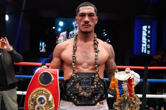 Jai Opetaia posing with his championship belts after his victory over Brandon Glanton at Zuffa Boxing 4
