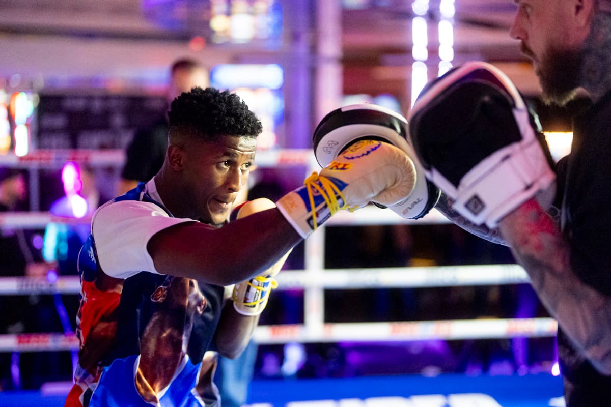 Jhon Orobio punching mitts during an open workout