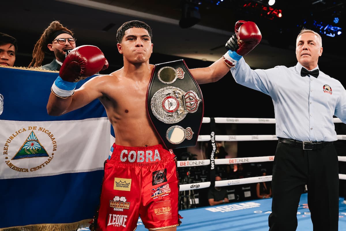 Jordan Orozco Hernandez raises his hands in victory over Daniel Olea during their boxing match