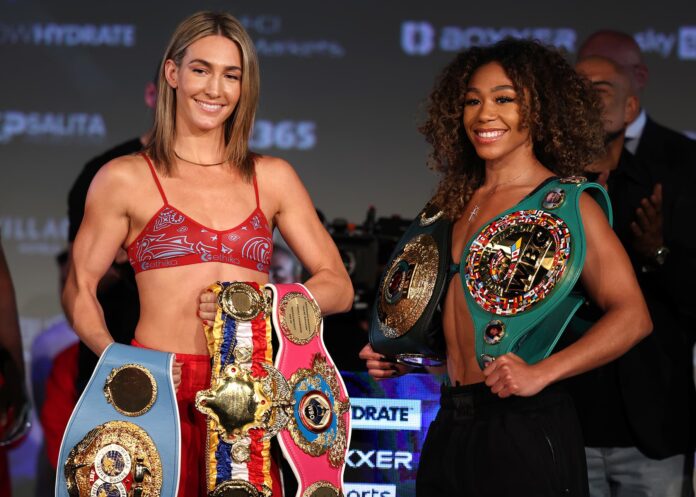 Mikaela Mayer and Alycia Baumgardner holding their belts at the weigh-in ahead of their boxing match