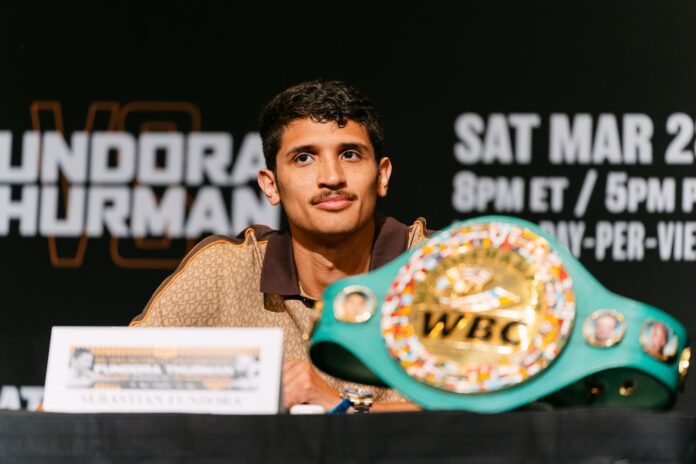 Sebastian Fundora at the press conference before his boxing match against Keith Thurman, WBC belt on the table