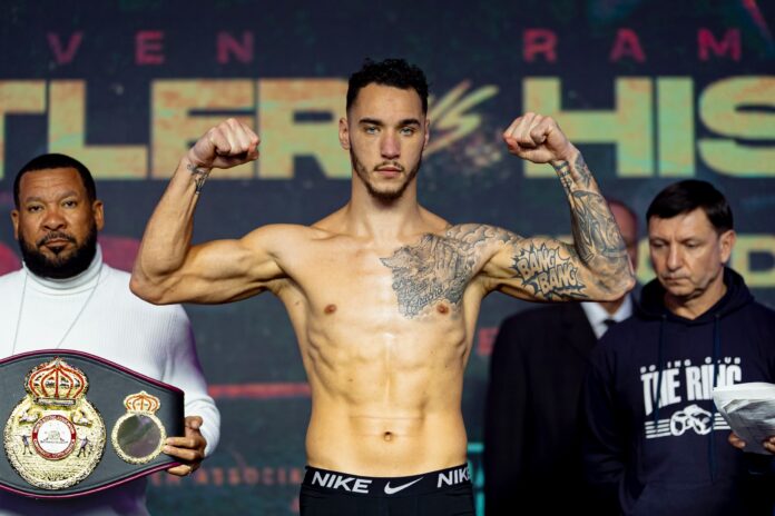 Steven Butler posing on the scales during the weigh-in ahead of his boxing match against Ramadan Hiseni in Montreal
