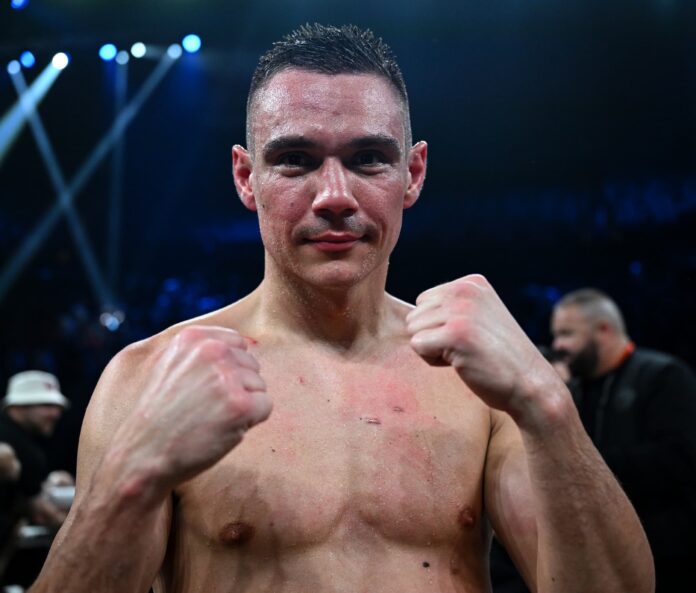 Tim Tszyu posing in a fighting stance with his hands up after a boxing victory