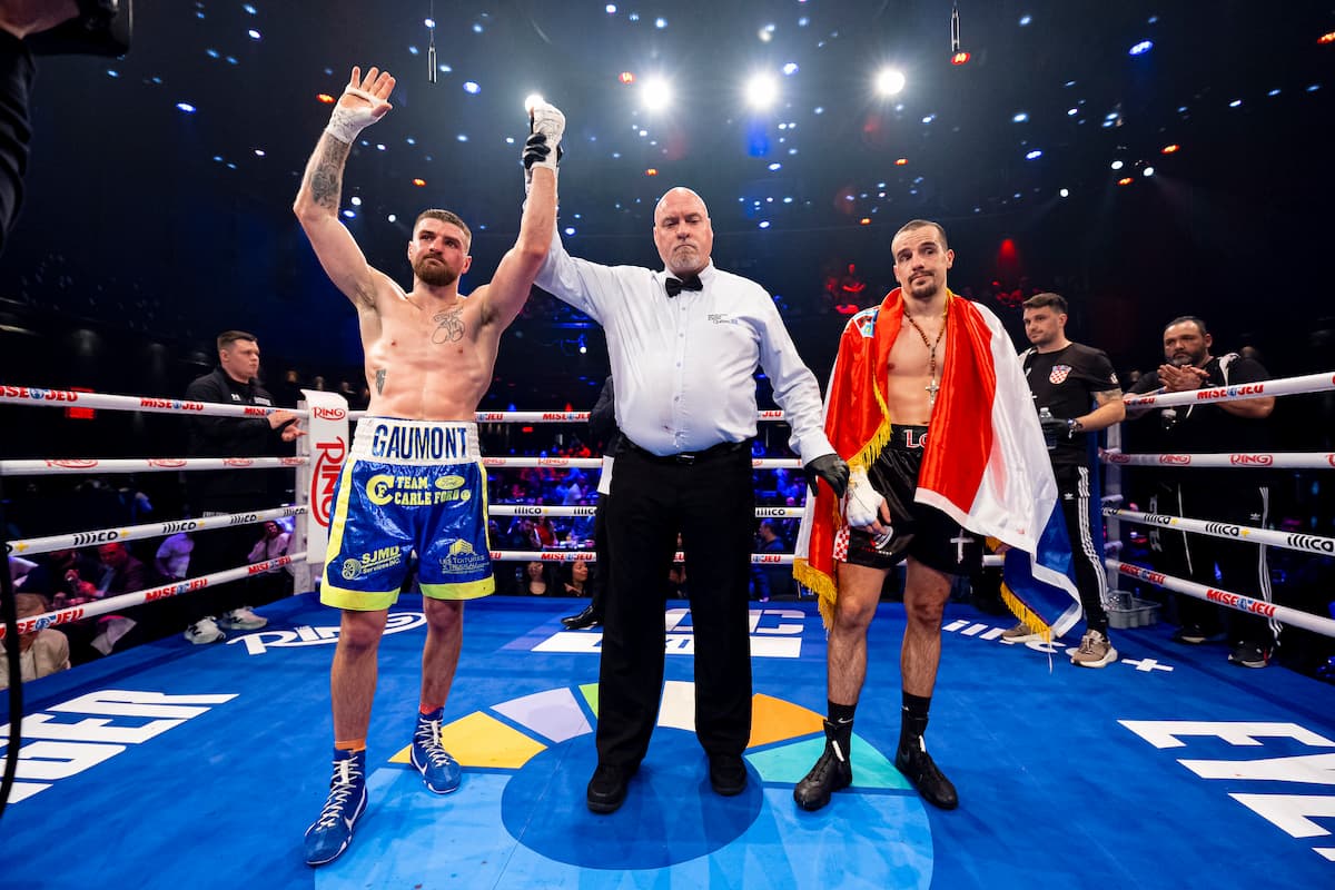The referee raises Alexandre Gaumont's hand in victory over Luka Lozo during their boxing match