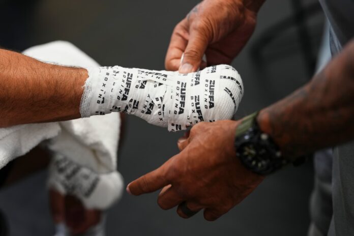 A boxer's hands being wrapped in a locker room prior to the Zuffa Boxing 4 event in Las Vegas