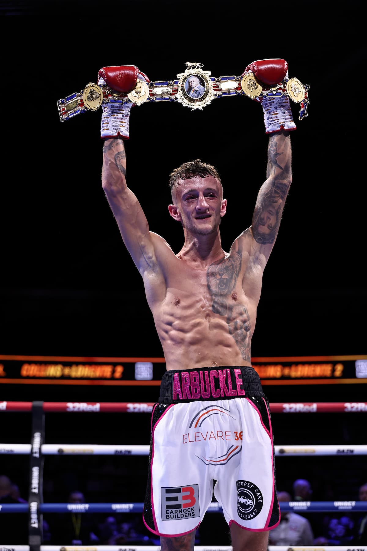 Dylan Arbuckle in the ring with his championship belts after his victory over Nico Leivars