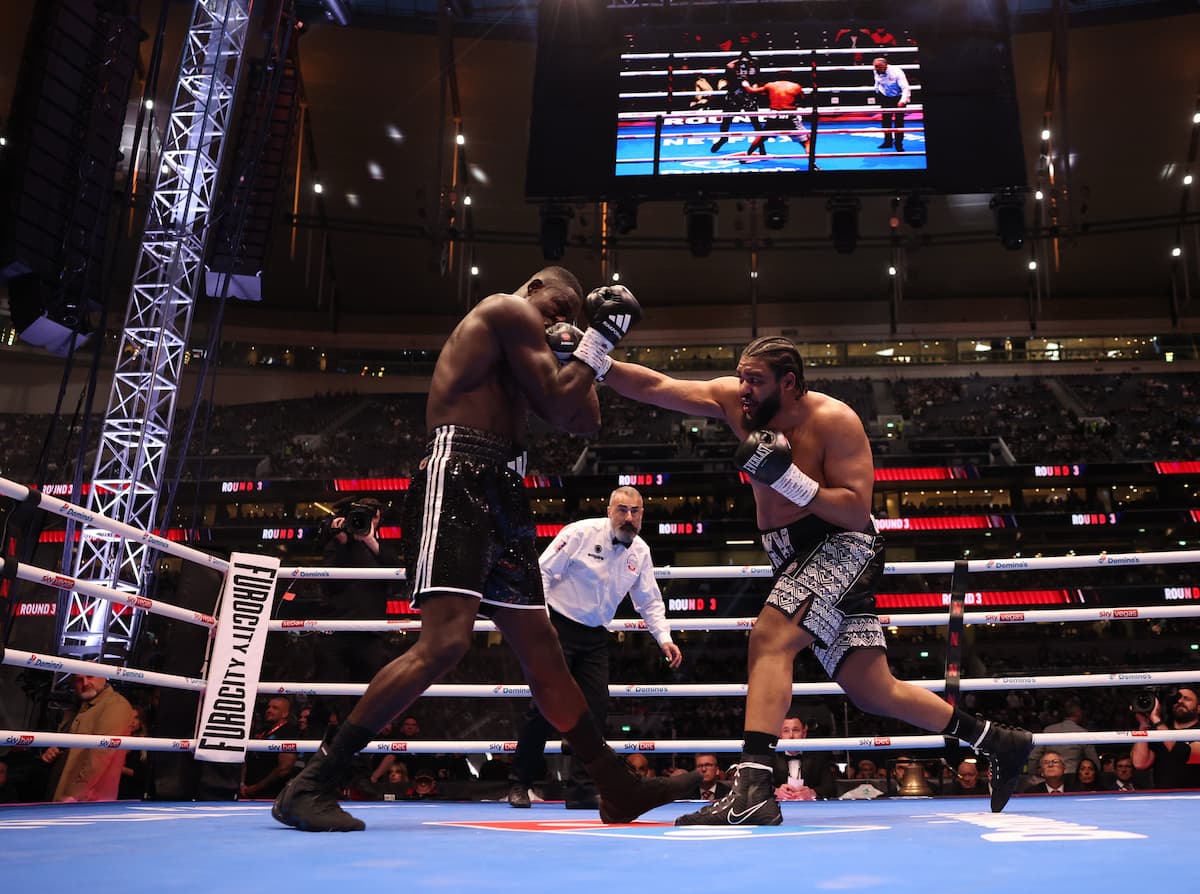 Jeamie Tshikeva lands a punch during his boxing match against Richard Riakporhe
