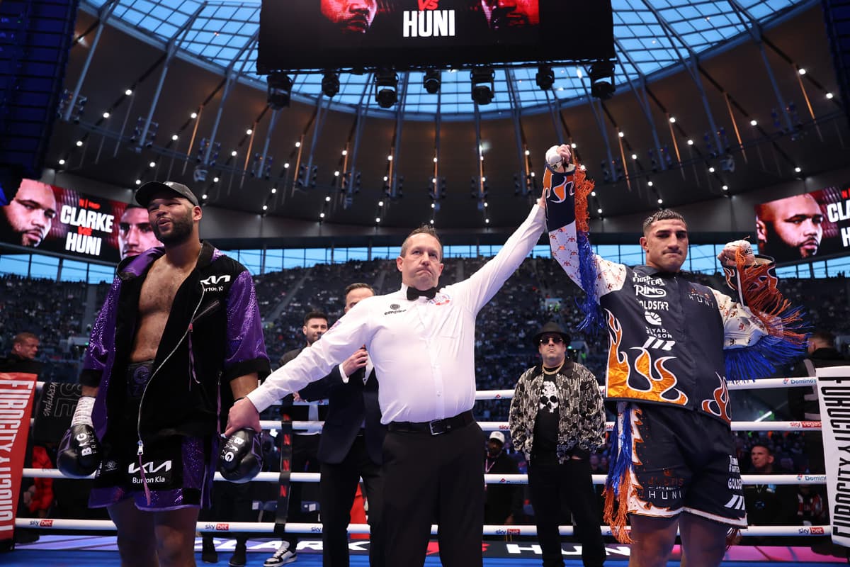 The referee raises Justis Huni's hand after his victory over Frazer Clarke