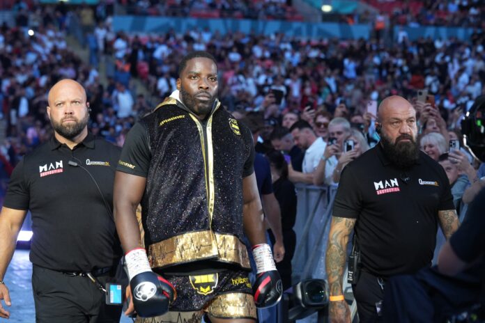 Lawrence Okolie walking out to the ring surrounded by security before his boxing match