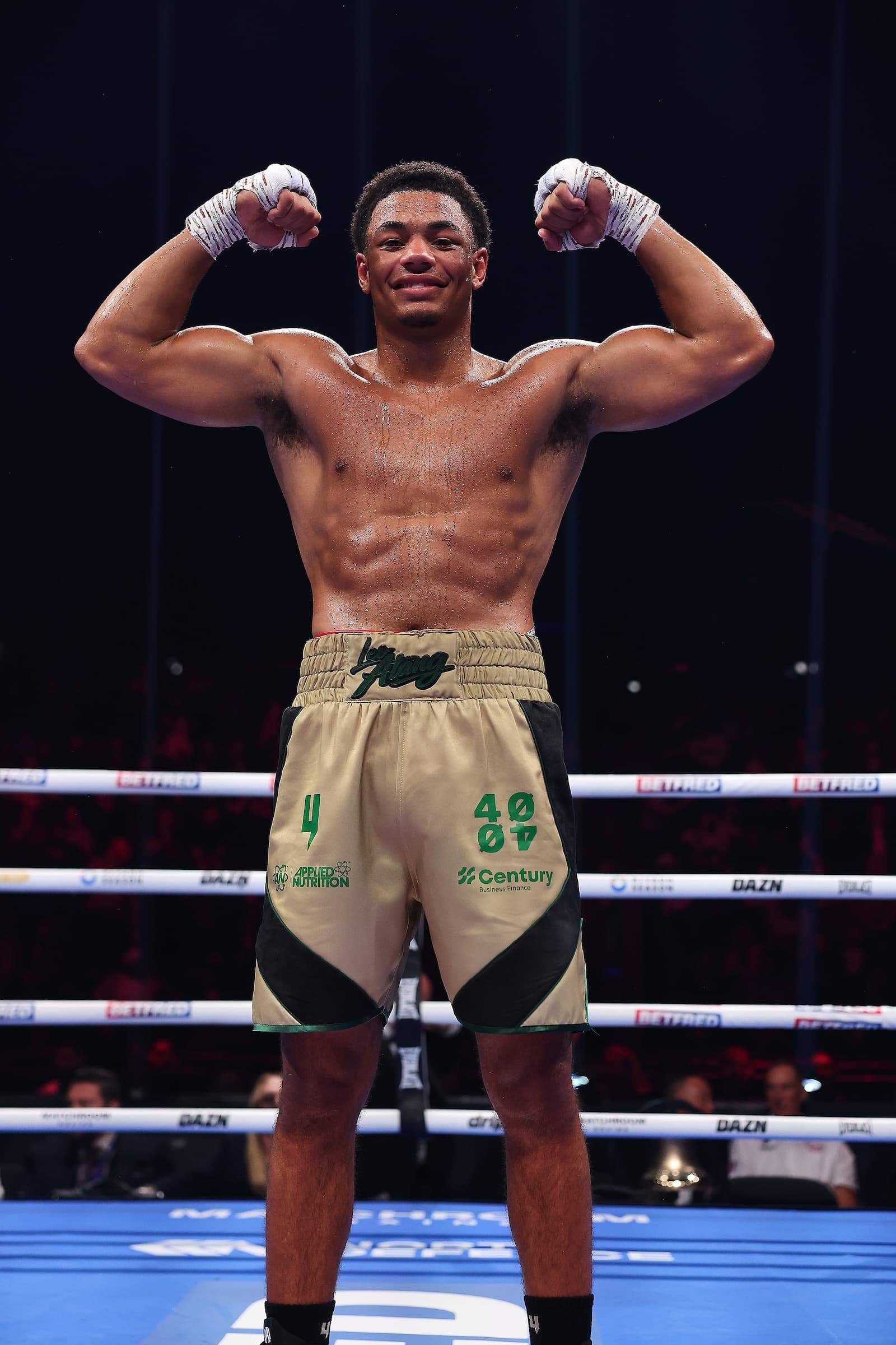 Leo Atang celebrates his victory in the ring after his heavyweight bout