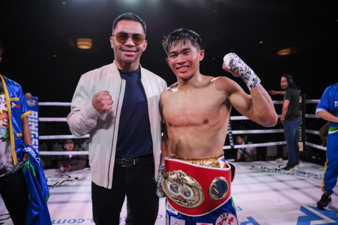 Manny Pacquiao and Pedro Taduran in the ring after Taduran's victory over Gustavo Perez during their boxing match