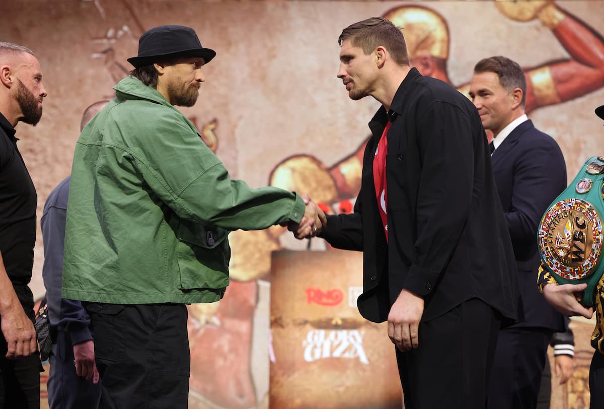 Oleksandr Usyk and Rico Verhoeven shake hands at a launch press conference ahead of their boxing match