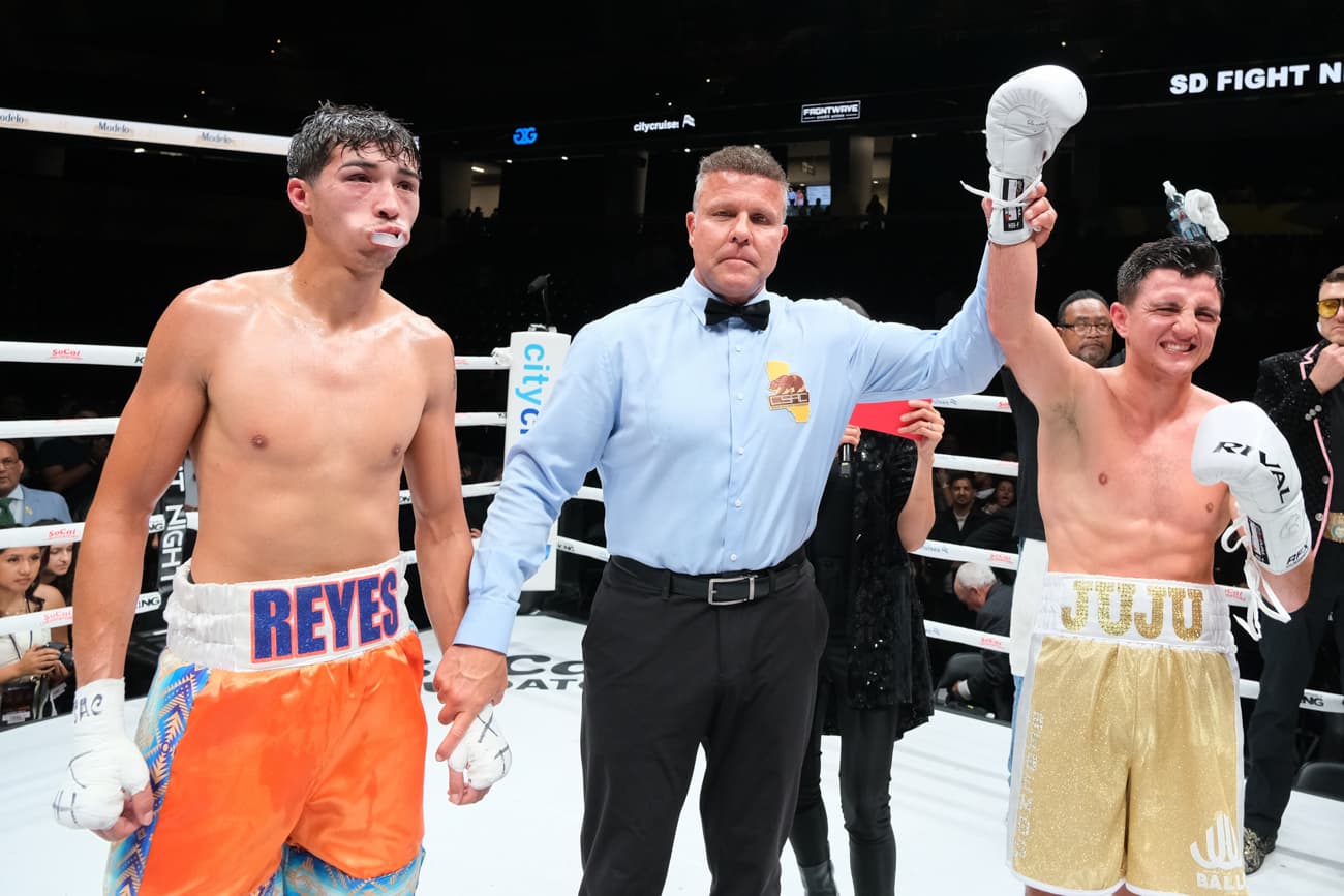 Referee Thomas Taylor raises Julius Ballo's hand in victory over Roman Reyes