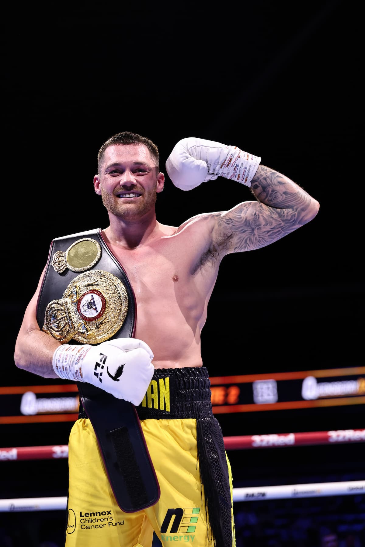 Sam Gilley celebrating in the ring with his championship belt after stopping Aston Brown in their title fight