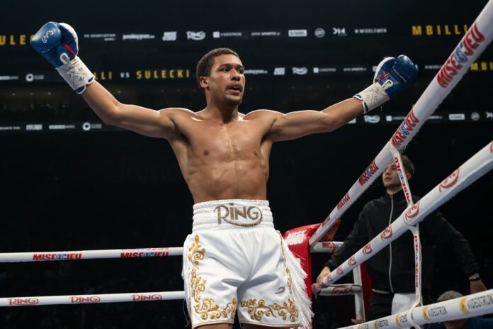 Wilkens Mathieu in the ring celebrating victory during his boxing match