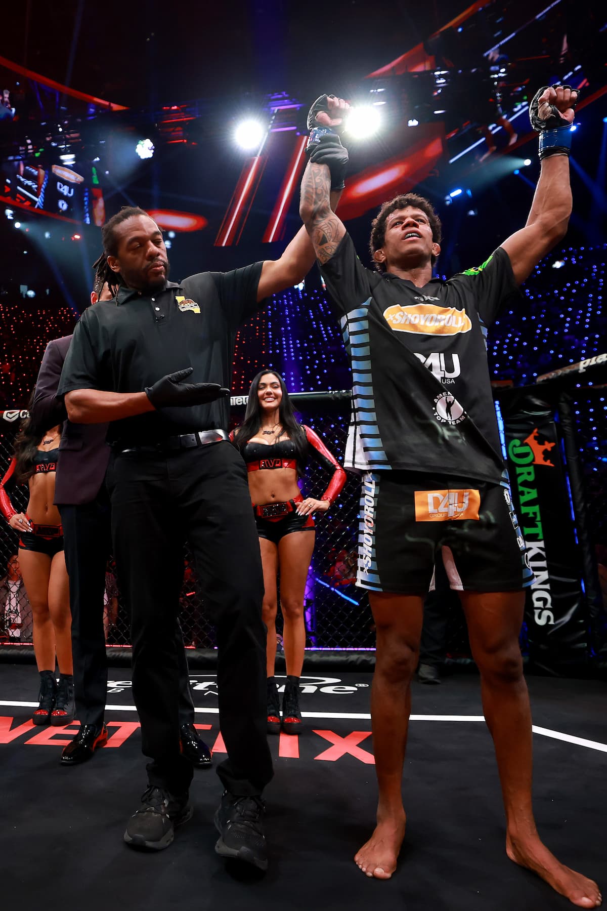 Adriano Moraes having his hand raised in victory