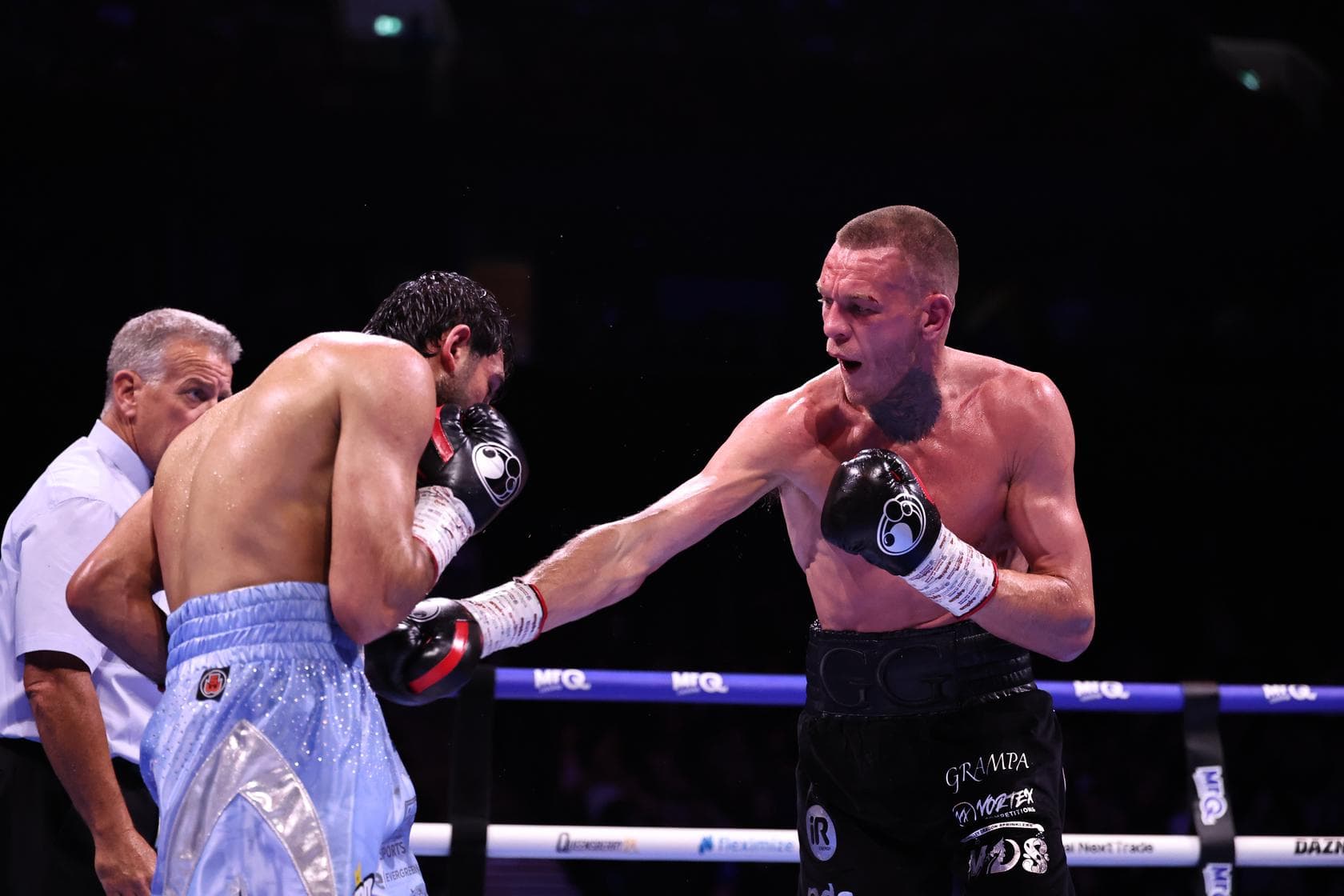 Gavin Gwynne lands a body punch during his bout against Khaleel Majid
