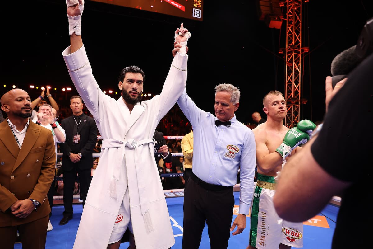 Hamza has his hand raised by the referee in victory after the bout