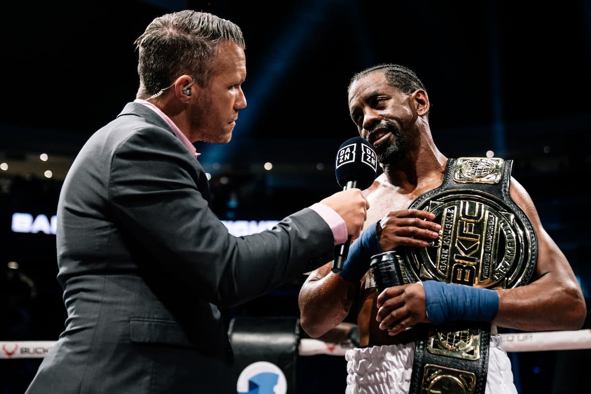 Jamel Herring speaks during his post-fight interview while holding the BKFC bantamweight title belt