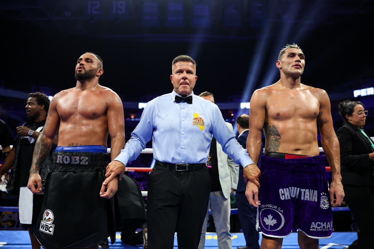 Robin Sirwan Safar and Yamil Alberto Peralta Jara with referee Thomas Taylor at end of bout