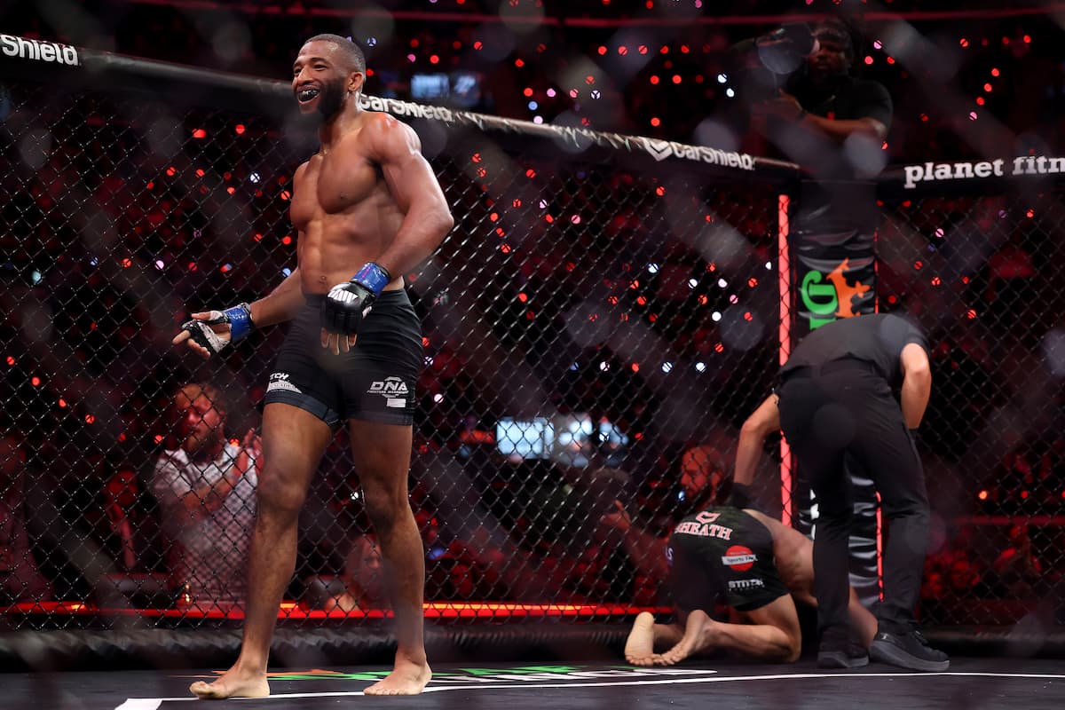 Salahdine Parnasse walking off as Kenneth Cross is down on the canvas