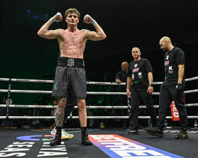 Sam Hickey posing in the ring after his victory