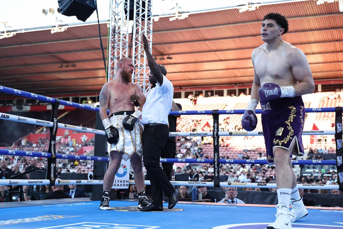 Adam Olaniyan walks off as the referee attends to Viktar Chvarkou after the stoppage