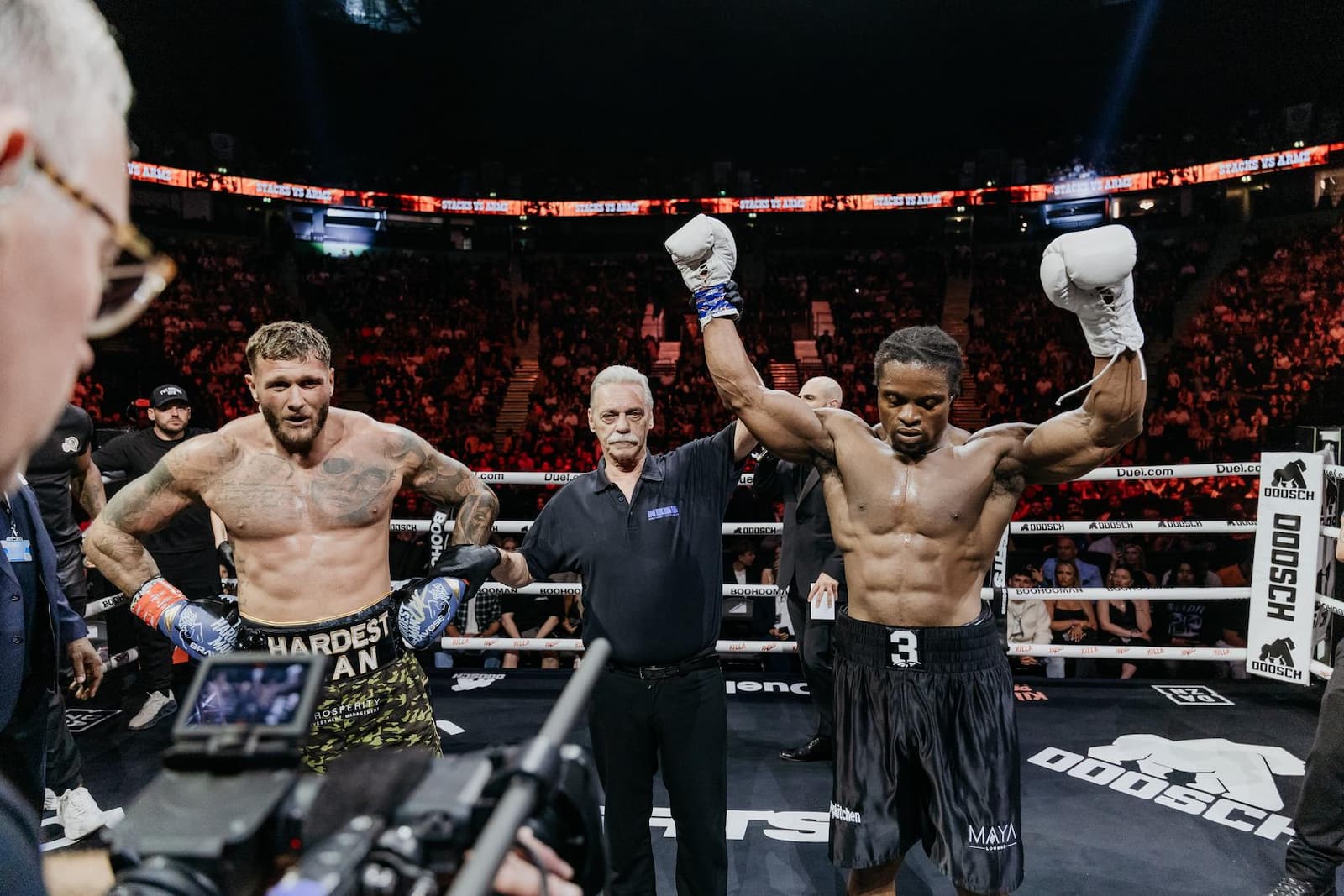 Baffour Boateng aka Armz Korleone has his hand raised in victory over Charlie Cox aka Big Stacks