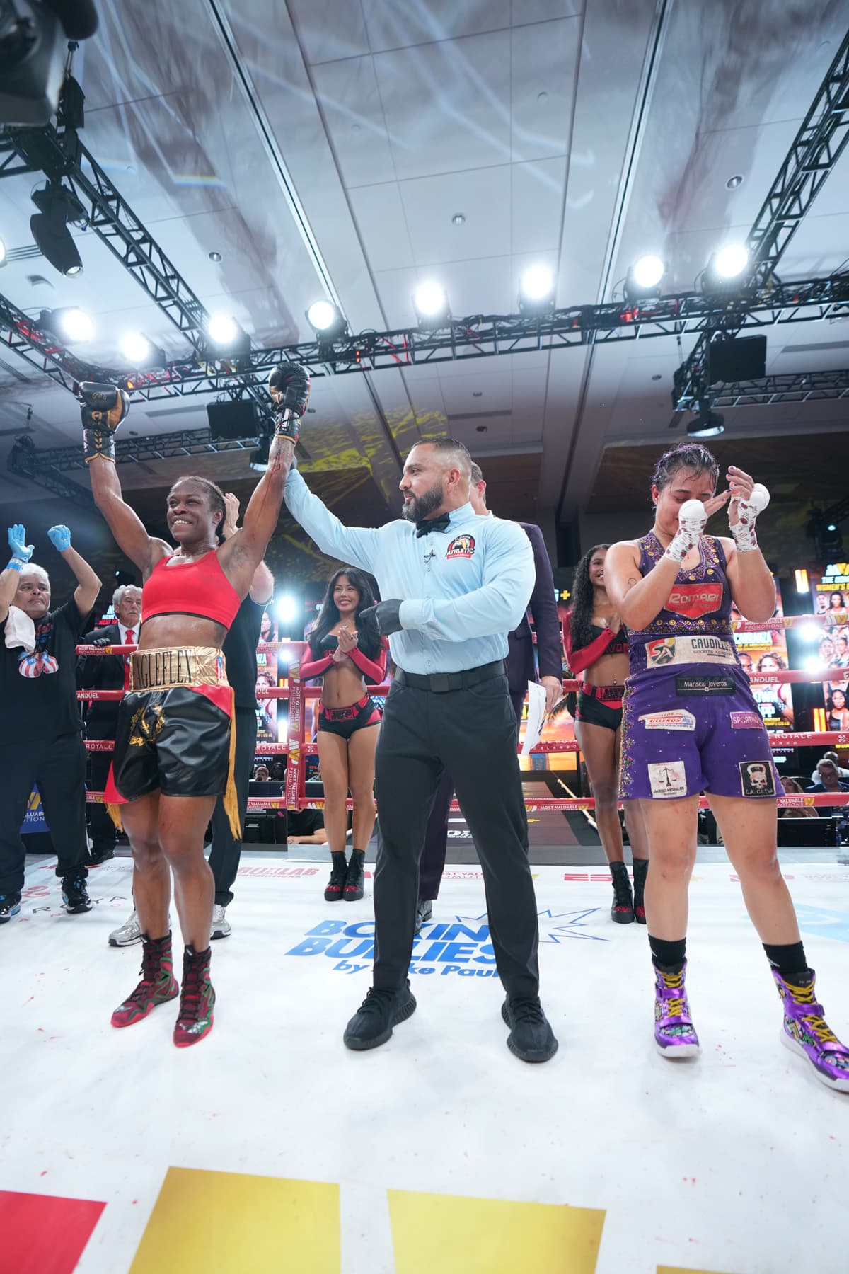 Brittany Sims has her hand raised by the referee after victory over Naomy Cardenas