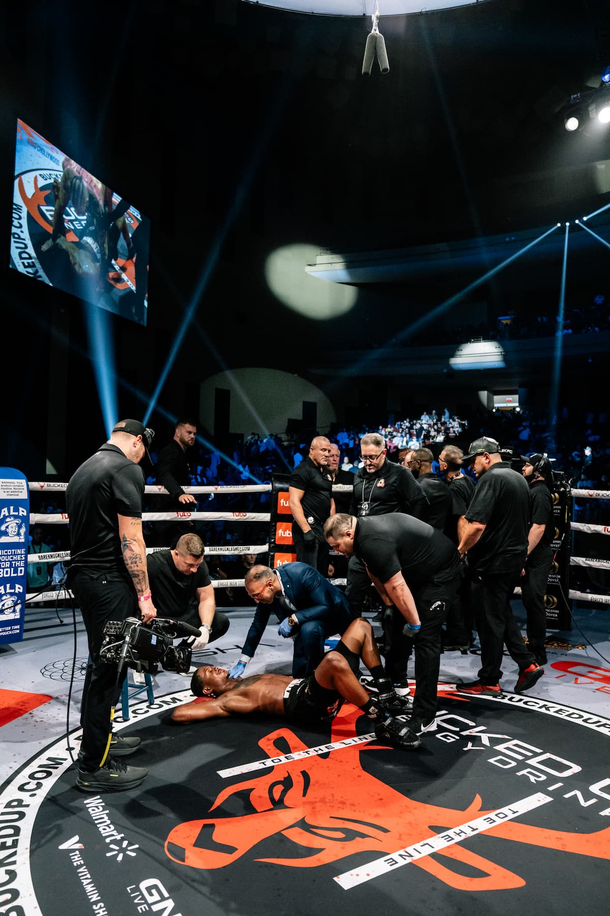 Bryce Henry on the ground after being taken down, with officials attending to him