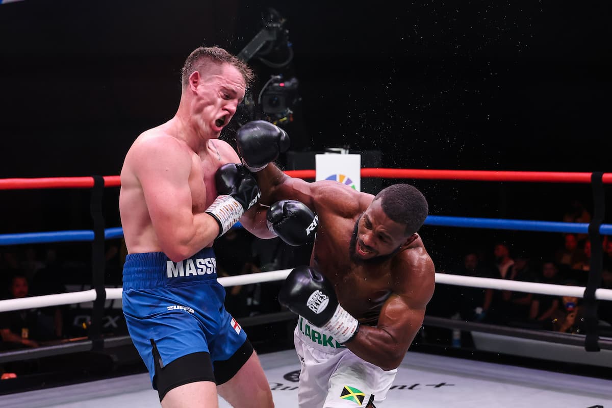 Cheavon Clarke lands a punch during his bout against Jack Massey