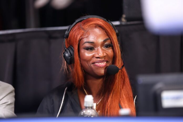 Claressa Shields ringside wearing a headset during the boxing event