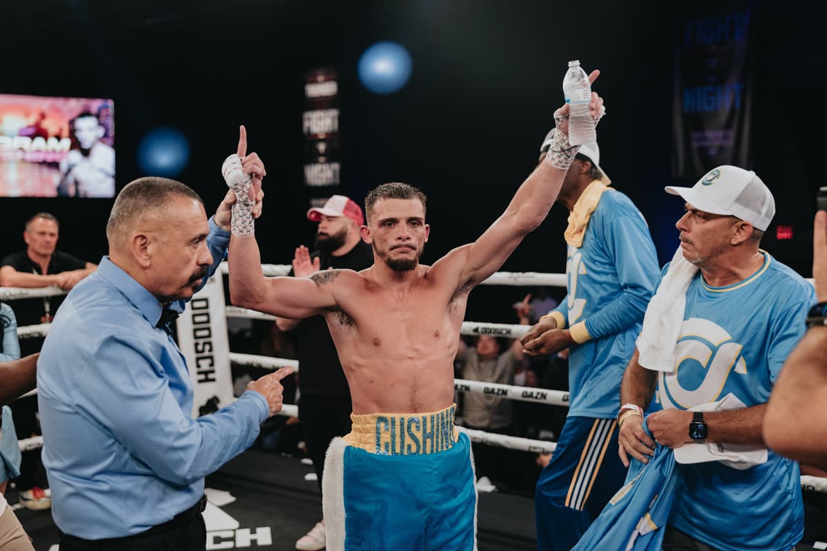 Devin Cushing has his hand raised by the referee after victory over J'Hon Ingram