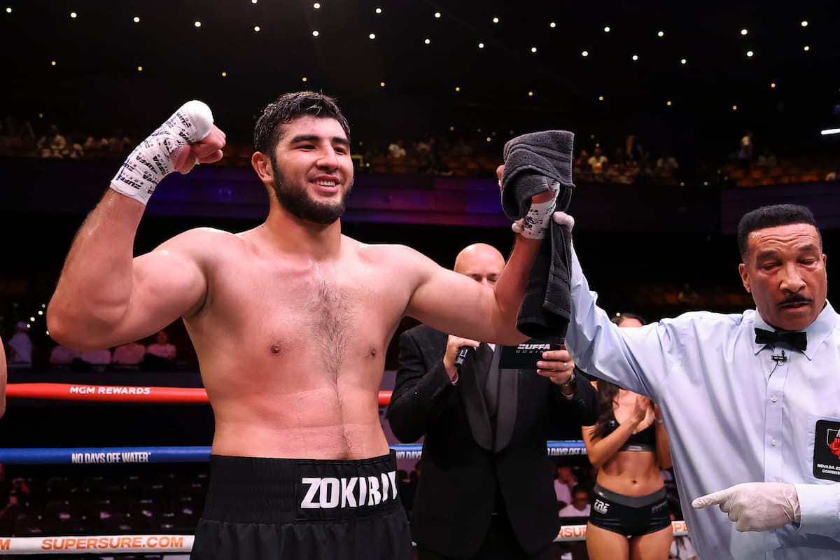 Jakhongir Zokirov has his hand raised by the referee
